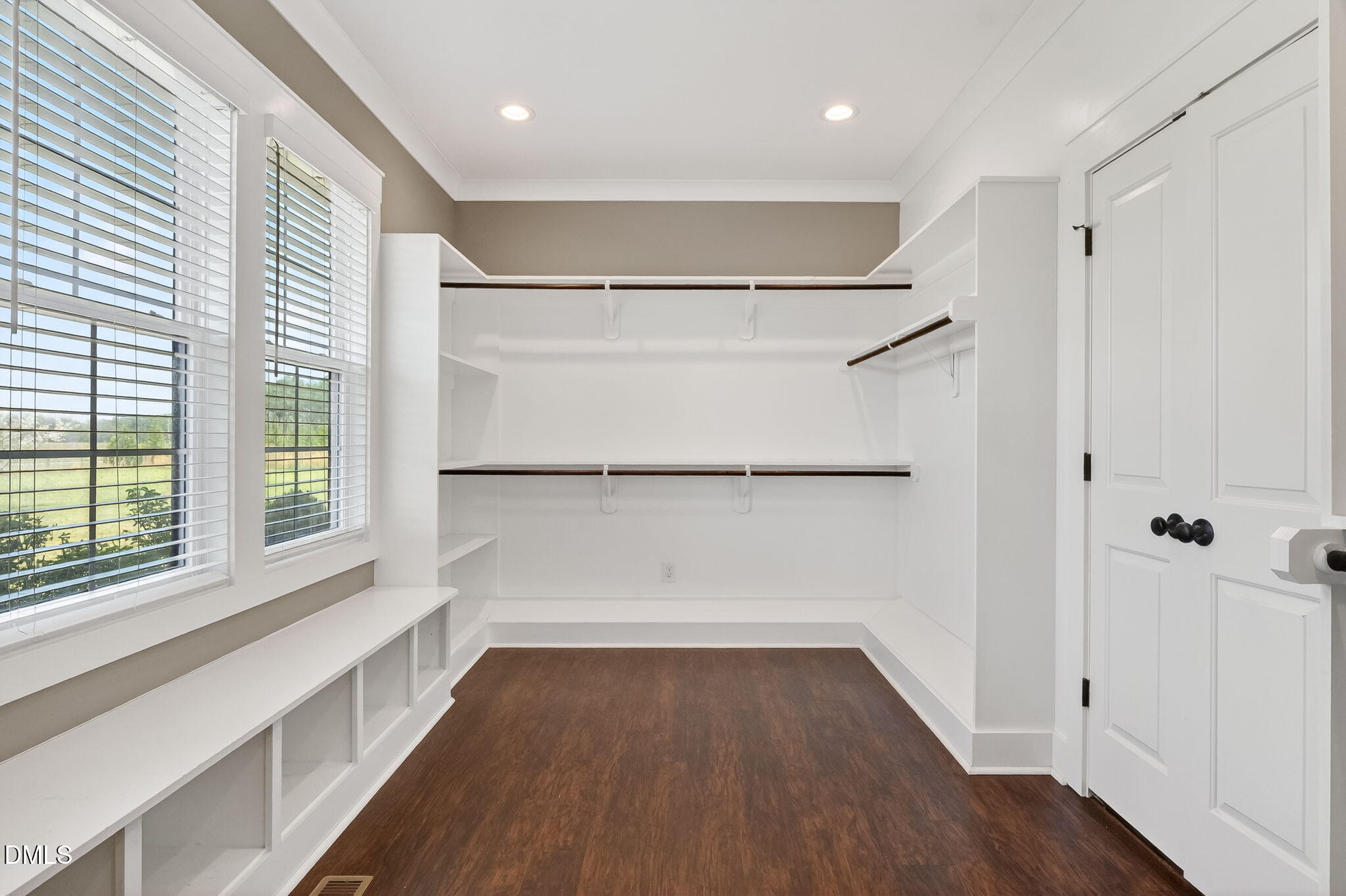 325 Old Stancil Road Kenly, NC 27542 - Photo 26 of 54 a view of walk in closet with wooden floor and window
