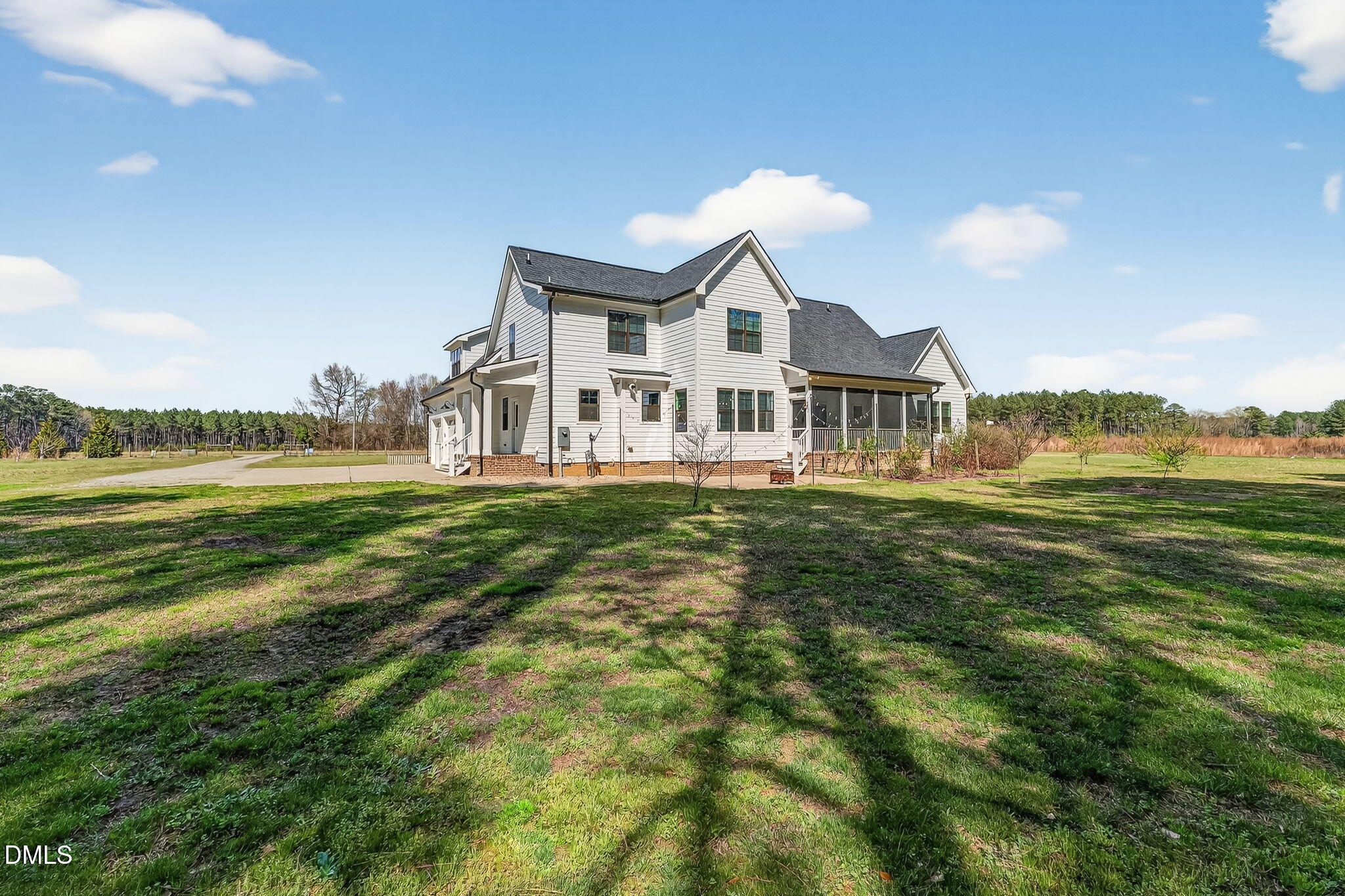 325 Old Stancil Road Kenly, NC 27542 - Photo 48 of 54 a front view of a house with a garden and lake view
