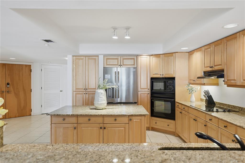 16326 Gulf Boulevard, Unit 307 Redington Beach, FL 33708 - Photo 6 of 43 a large kitchen with cabinets