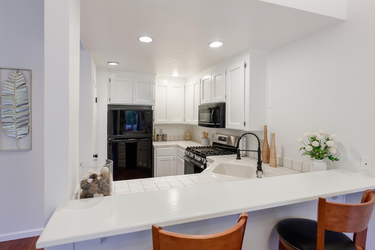 132 Arabian Way Scotts Valley, CA 95066 - Photo 17 of 82 a kitchen with stainless steel appliances a sink a stove a microwave a refrigerator and cabinets