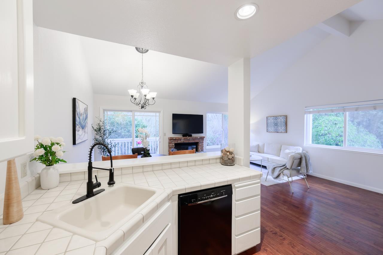 132 Arabian Way Scotts Valley, CA 95066 - Photo 22 of 82 a room with kitchen island a potted plant on the counter and a wooden floor