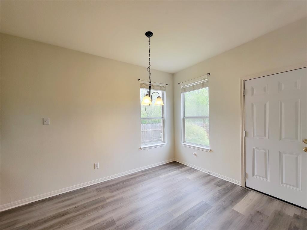 6708 Kilt Court Austin, TX 78754 - Photo 14 of 32 an empty room with wooden floor and windows