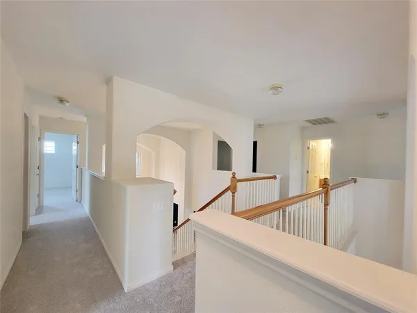 a view of a hallway with white walls