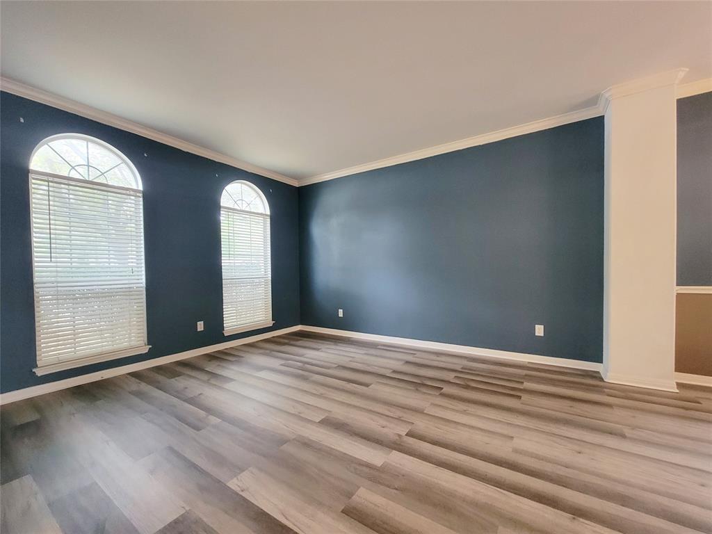 6708 Kilt Court Austin, TX 78754 - Photo 5 of 32 a view of an empty room with wooden floor and a window