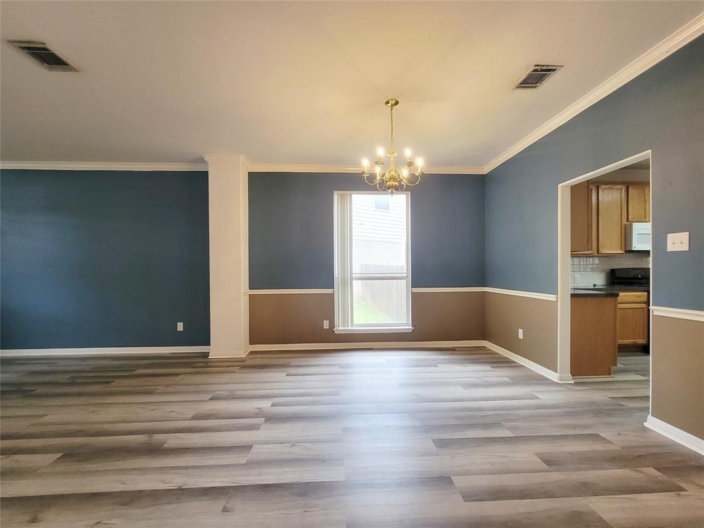 6708 Kilt Court Austin, TX 78754 - Photo 7 of 32 a view of a livingroom with wooden floor and kitchen