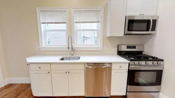 a kitchen with a stove and a microwave