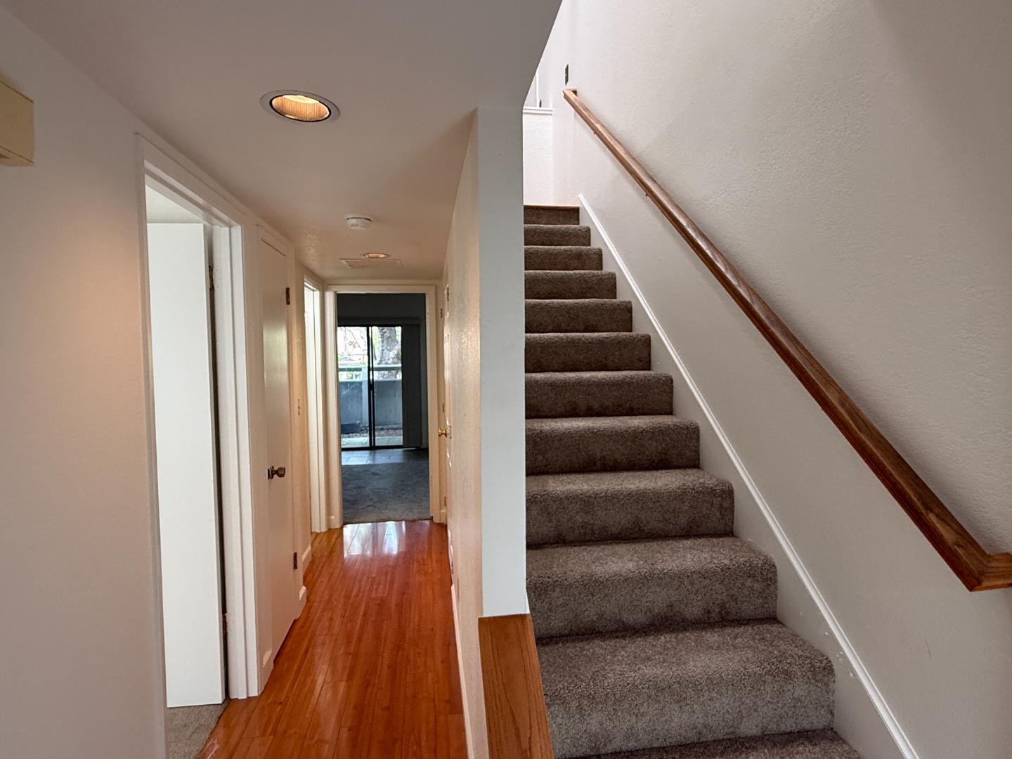111 Bean Creek Road, Unit 146 Scotts Valley, CA 95066 - Photo 9 of 13 a view of staircase with white walls and wooden floor