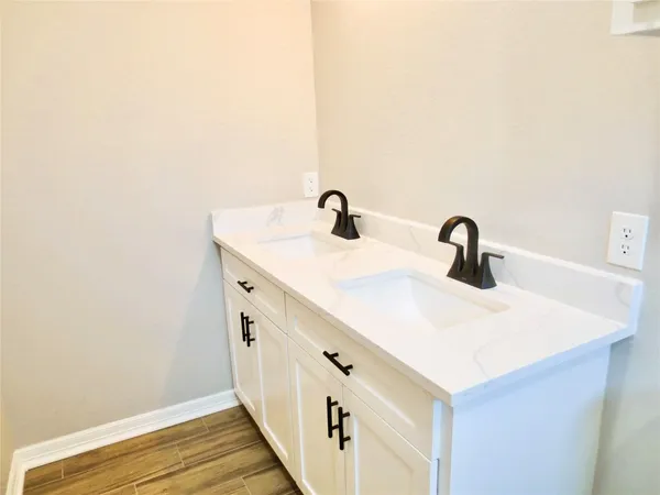 a bathroom with a double vanity sink and mirror