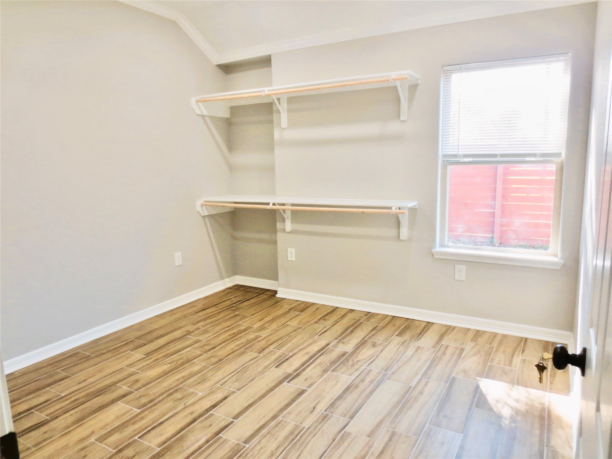 10316 Aldine Westfield Road Houston, TX 77093 - Photo 12 of 13 a view of an empty room with wooden floor and a window