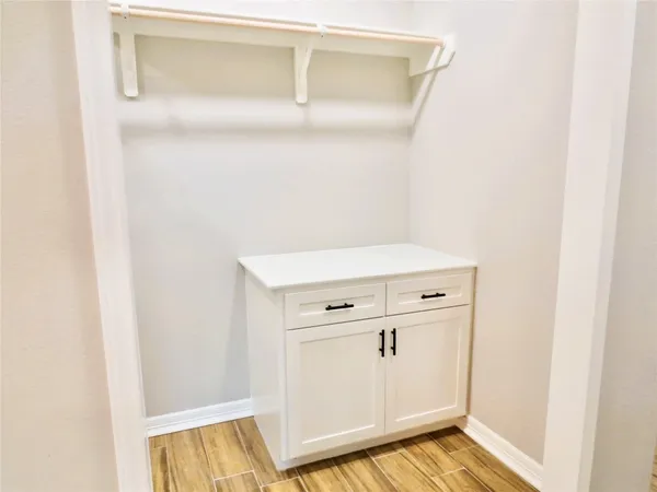 a view of walk in closet with cabinet