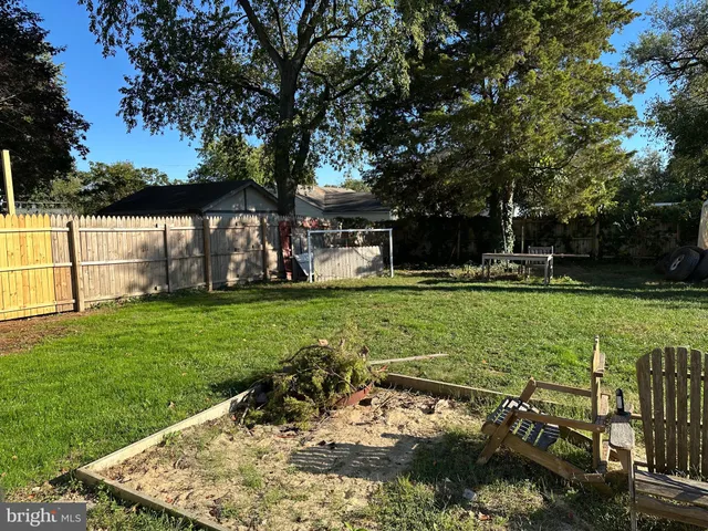 a view of a house with a big yard and sitting area