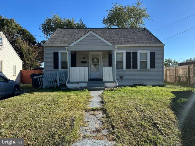 a house with green field in front of it