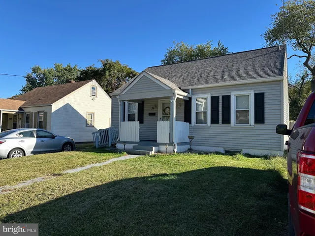 a view of a house with a yard and sitting area