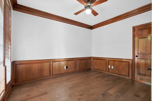 a bathroom with a bathtub a window a shower and checkered floor
