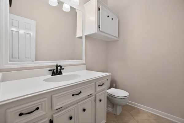 a spacious bathroom with a double vanity sink a mirror a window and a bathtub