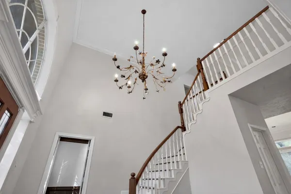 a kitchen with stainless steel appliances granite countertop a stove top oven a sink dishwasher a dining table and chairs with wooden floor