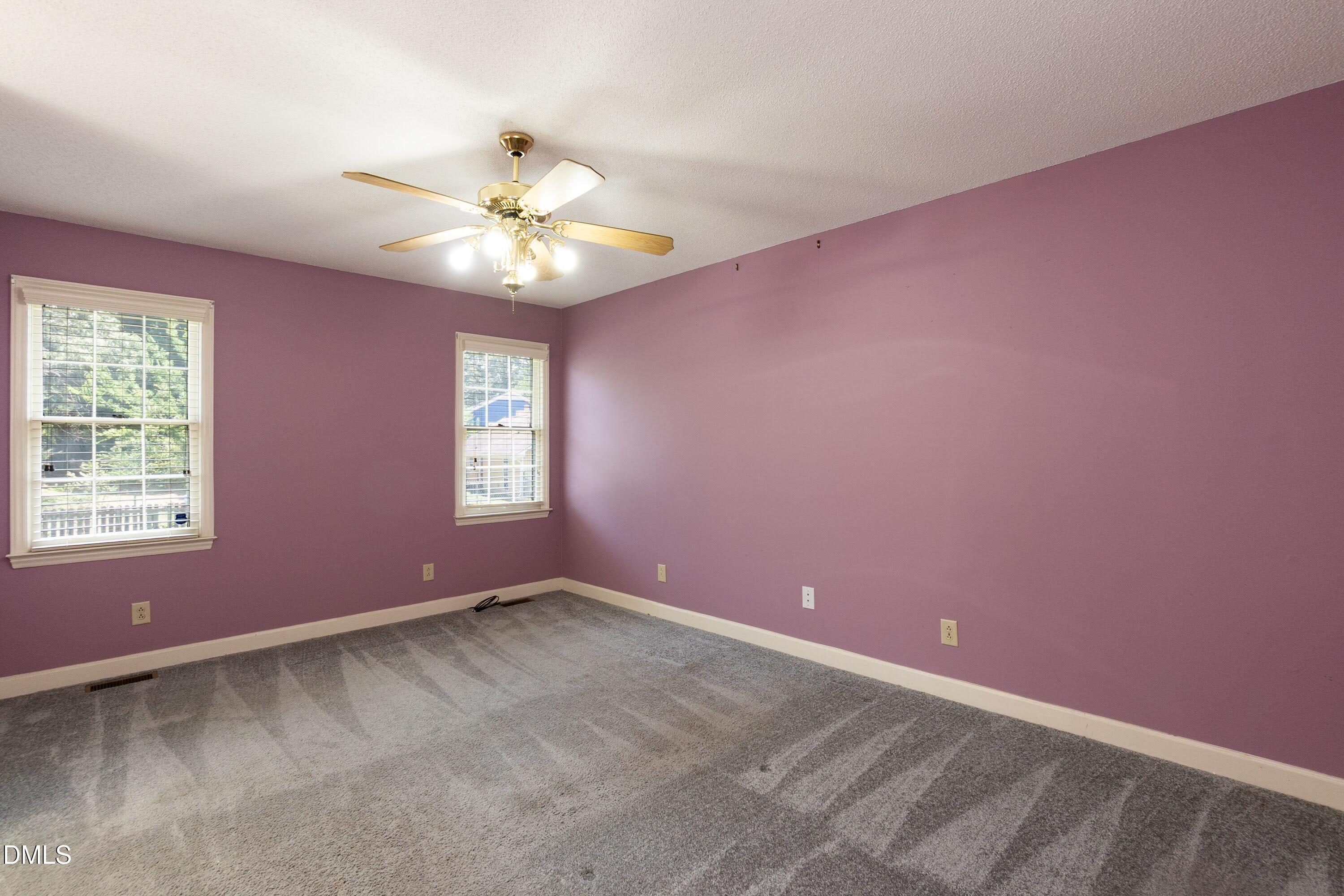 5604 Spring Pines Way Raleigh, NC 27616 - Photo 10 of 22 an empty room with a window and a fan