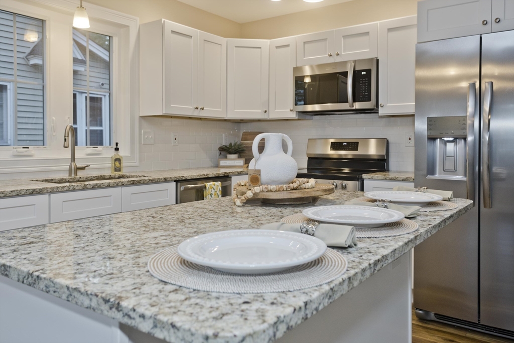 40 Preston Street Springfield, MA 01109 - Photo 1 of 32 a kitchen with stainless steel appliances granite countertop a sink a stove and a microwave
