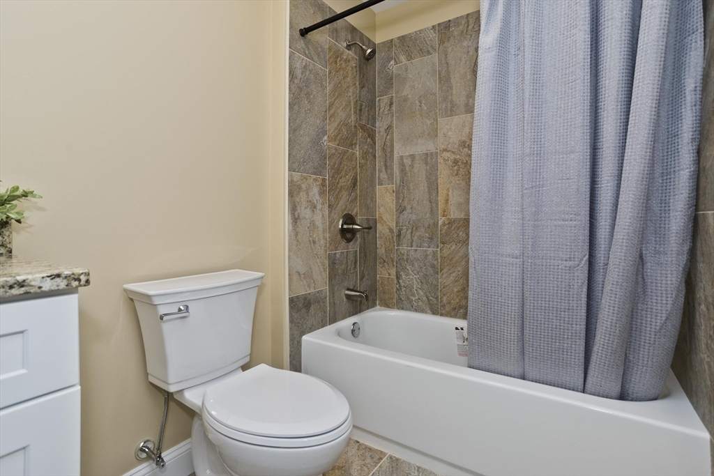 40 Preston Street Springfield, MA 01109 - Photo 18 of 32 a white toilet sitting next to a bath tub