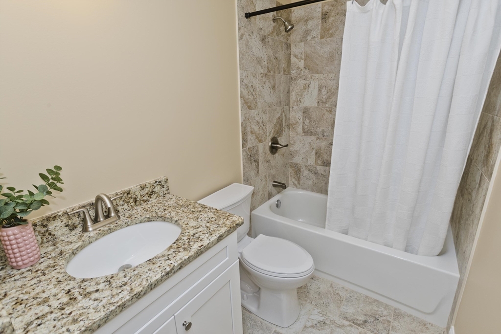 40 Preston Street Springfield, MA 01109 - Photo 25 of 32 a bathroom with a granite countertop sink toilet and shower