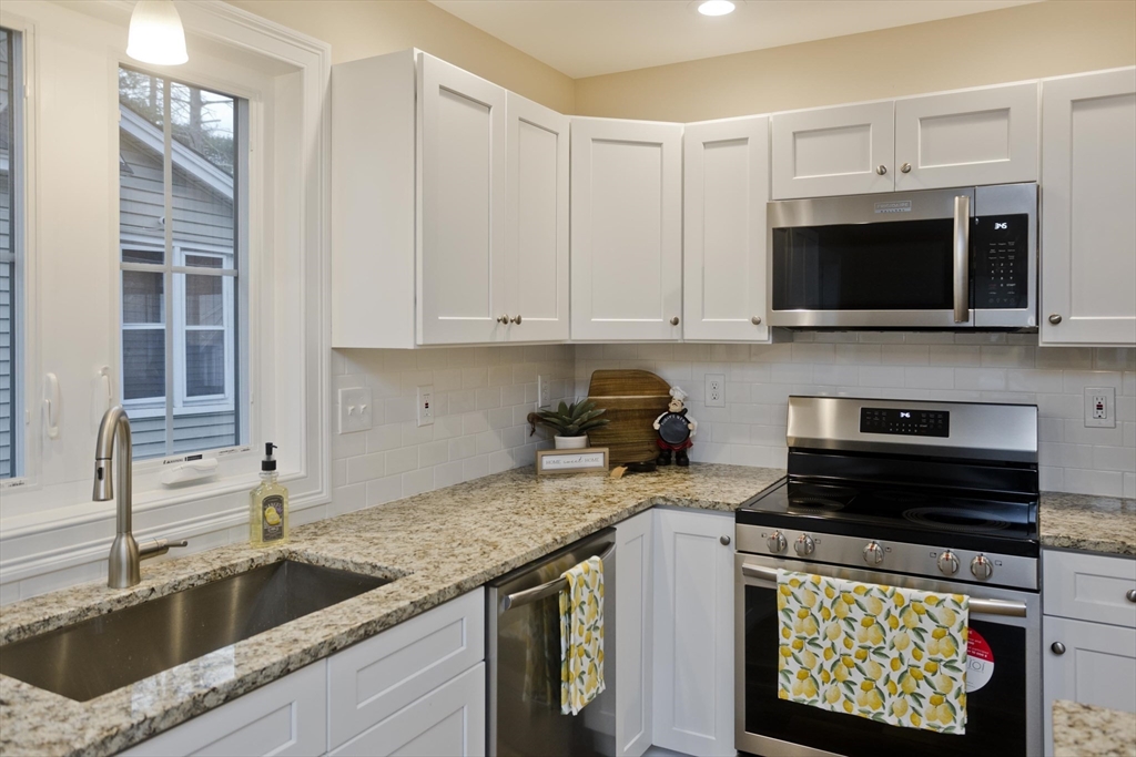 40 Preston Street Springfield, MA 01109 - Photo 4 of 32 a kitchen with stainless steel appliances granite countertop a sink a stove a microwave and a refrigerator
