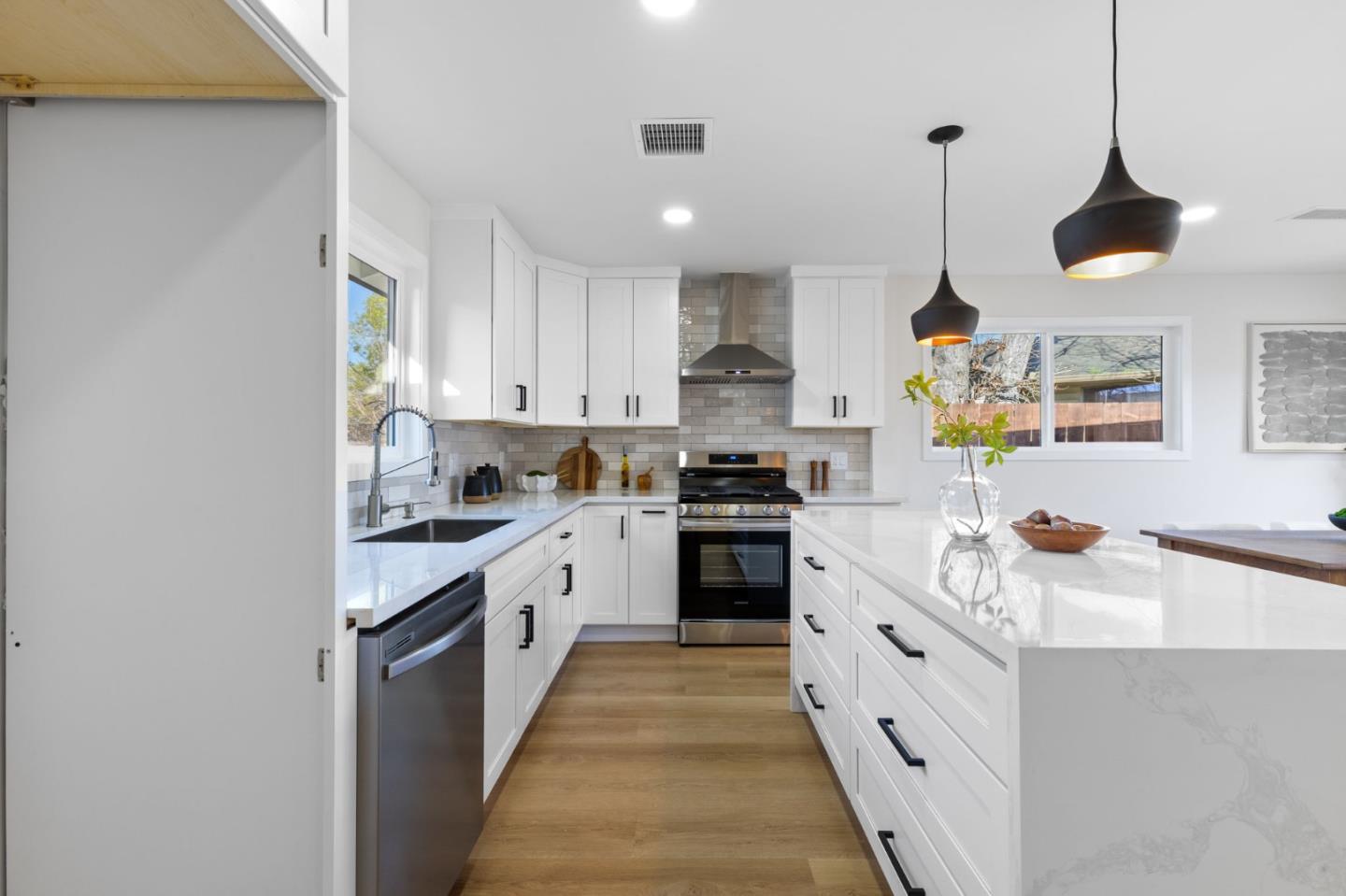 390 Valmy Street Milpitas, CA 95035 - Photo 14 of 37 a kitchen with kitchen island granite countertop stainless steel appliances a sink a stove top oven a counter space and cabinets