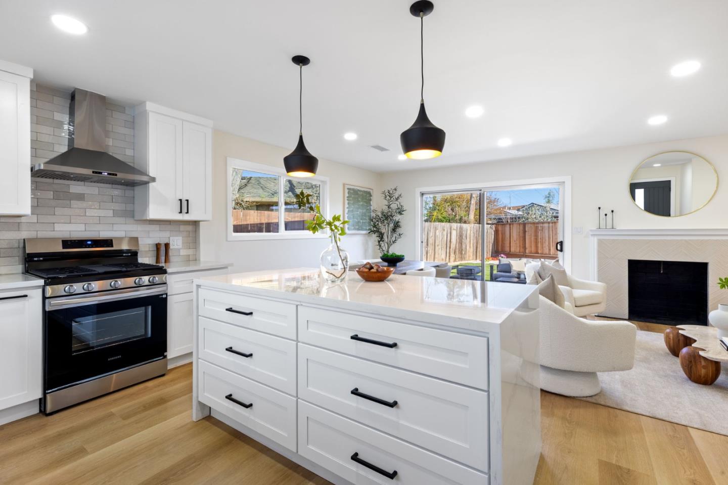 390 Valmy Street Milpitas, CA 95035 - Photo 16 of 37 a kitchen with stainless steel appliances kitchen island granite countertop a stove a sink and a wooden floors