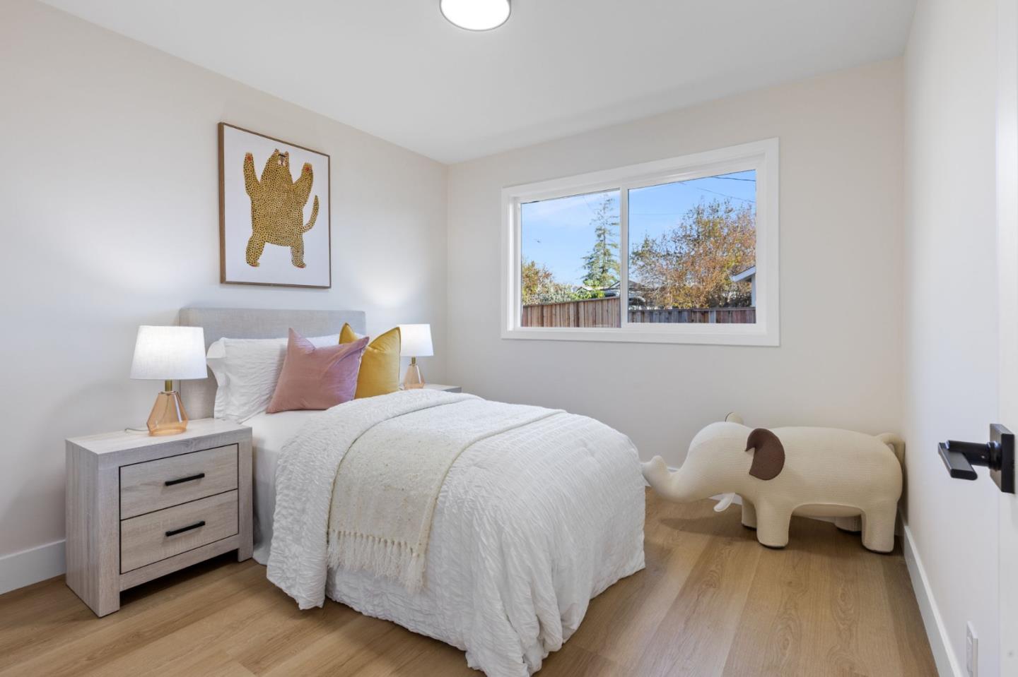 390 Valmy Street Milpitas, CA 95035 - Photo 22 of 37 a bedroom with a bed and wooden floor