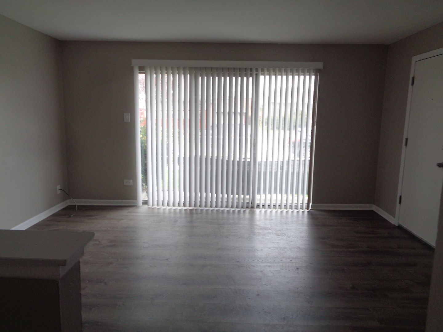 6045 Marshall Avenue, Unit 1W Chicago Ridge, IL 60415 - Photo 2 of 10 an empty room with wooden floor and windows