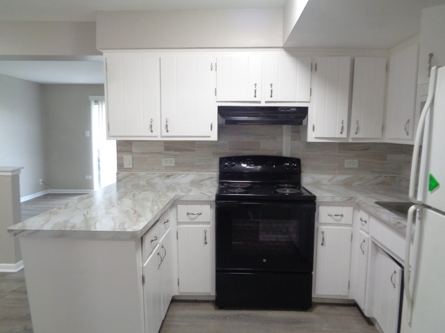 6045 Marshall Avenue, Unit 1W Chicago Ridge, IL 60415 - Photo 4 of 10 a kitchen with stainless steel appliances granite countertop white cabinets and a stove