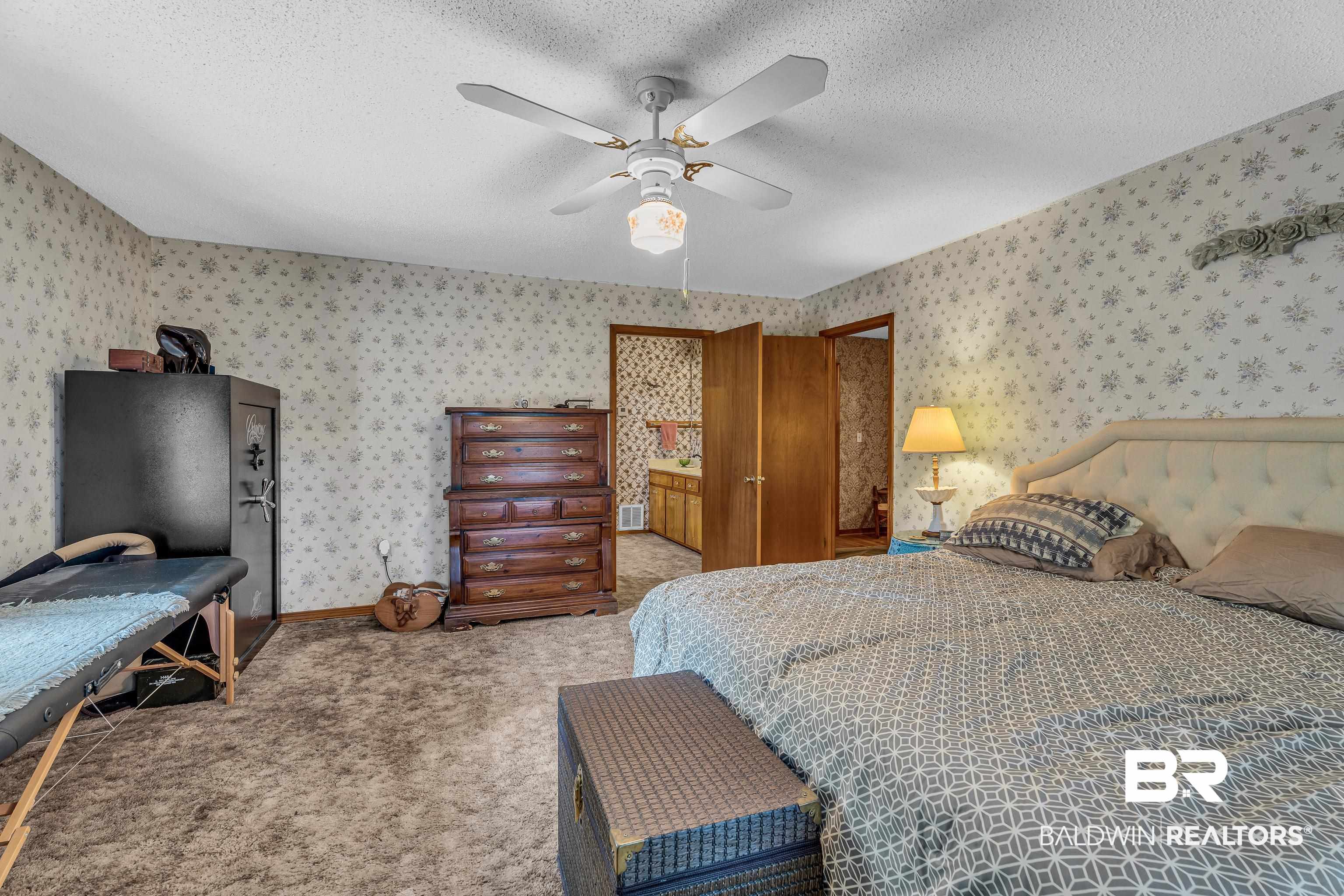 72075 Highway 59 Little River, AL 36550 - Photo 16 of 40 Bedroom with carpet, ceiling fan, and a textured ceiling