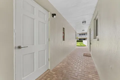 a view of hallway with wooden floor