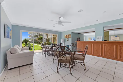 a living room with furniture and a dining table with chairs