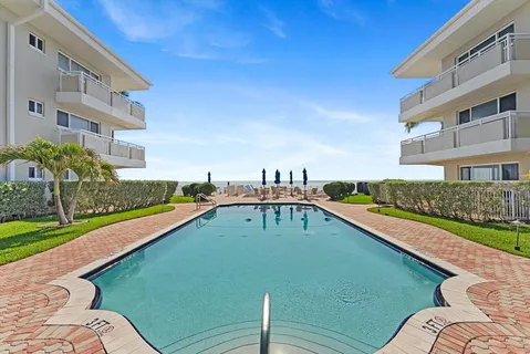 a view of a swimming pool with a yard