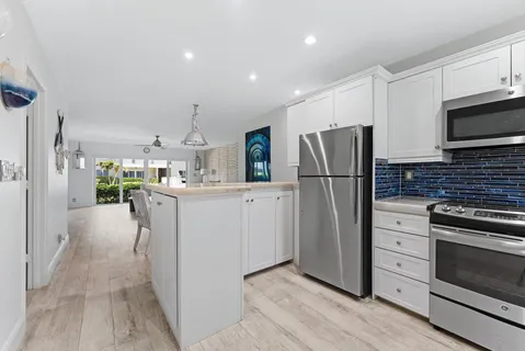 a kitchen with a refrigerator and a sink