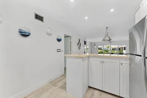 a kitchen with cabinets and wooden floor