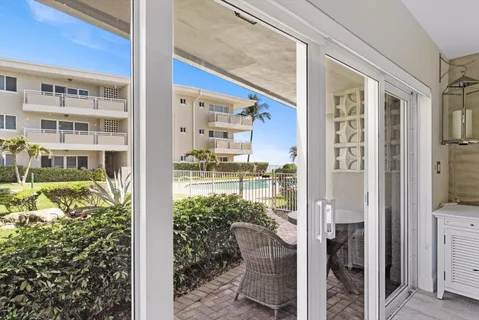 a balcony with a glass door and shower