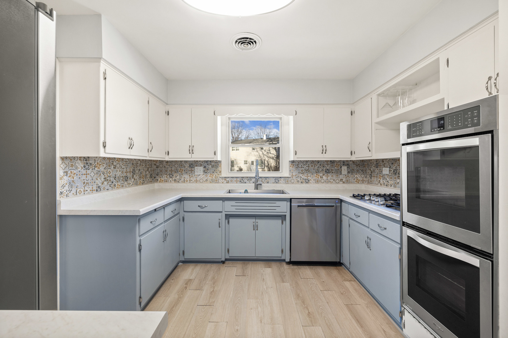272 Scott Street Wheeling, IL 60090 - Photo 3 of 12 a kitchen with granite countertop stainless steel appliances and white cabinets