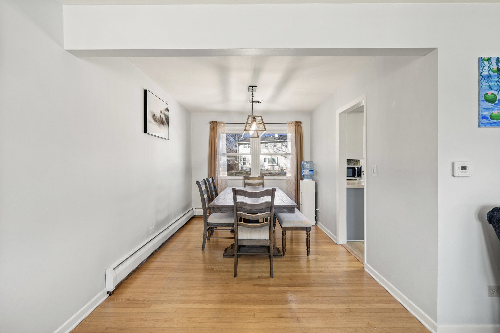 272 Scott Street Wheeling, IL 60090 - Photo 4 of 12 a dining room with wooden floor and a rug