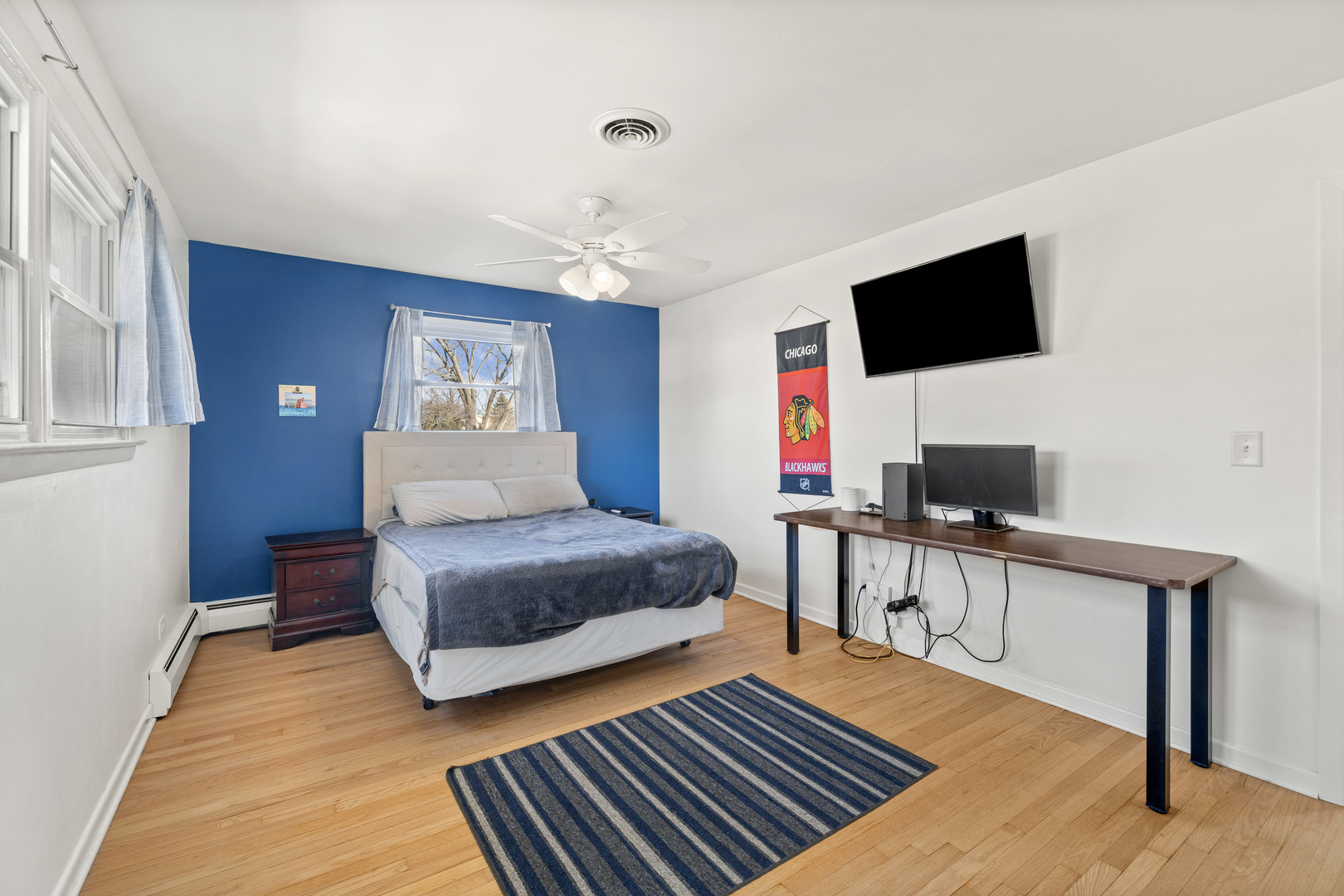 272 Scott Street Wheeling, IL 60090 - Photo 5 of 12 a bedroom with a bed and a flat screen tv