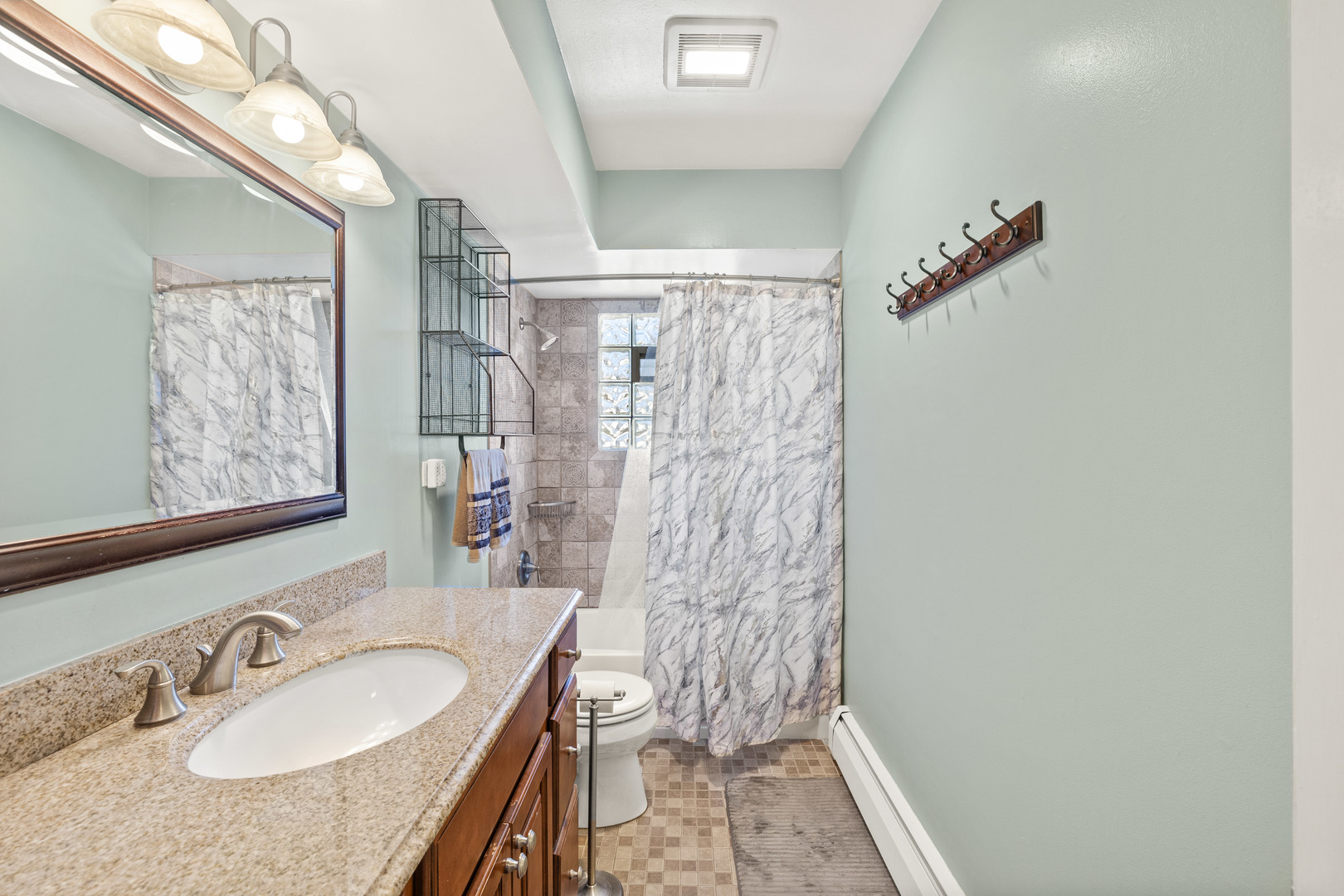272 Scott Street Wheeling, IL 60090 - Photo 6 of 12 a bathroom with a granite countertop sink a mirror and a shower