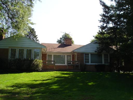 937 Illinois Road Wilmette, IL 60091 - Photo 11 of 13 a front view of a house with a garden