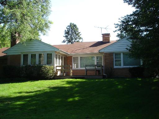 937 Illinois Road Wilmette, IL 60091 - Photo 13 of 13 a front view of a house with a garden and porch