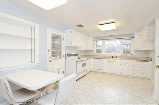 937 Illinois Road Wilmette, IL 60091 - Photo 5 of 13 a large white kitchen with cabinets