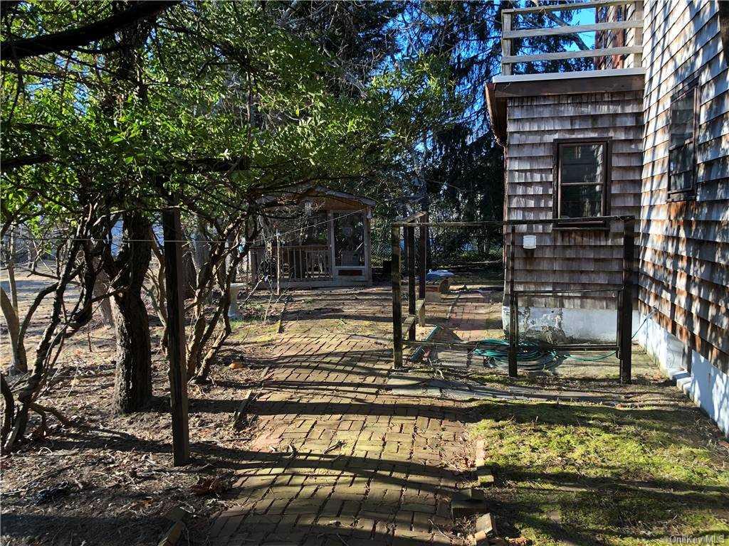 49 Shrubland Road Southampton, NY 11968 - Photo 2 of 9 a view of a pool with a tree