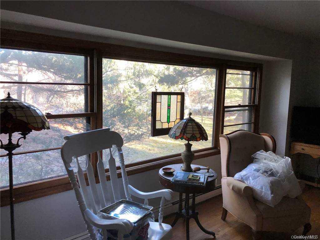 49 Shrubland Road Southampton, NY 11968 - Photo 5 of 9 a living room with furniture and a large window