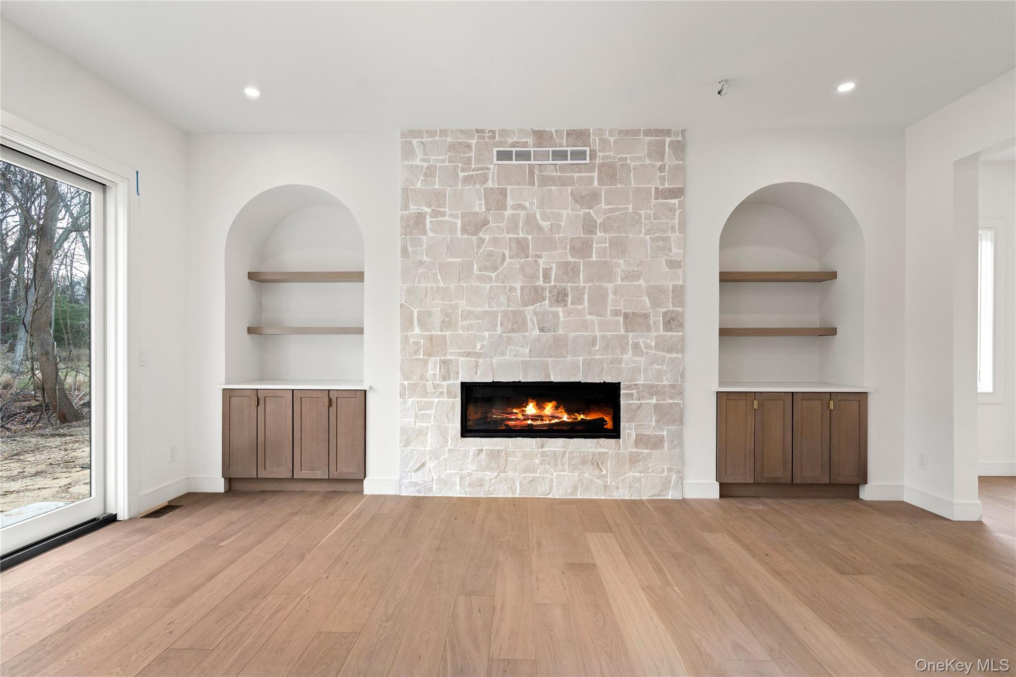 9 Wilderness Road St. James, NY 11780 - Photo 13 of 44 Family Room, Wide Plank White Oak Flooring, Custom Built In Entertainment Center with Rounded Archways, Floor to Ceiling Stone Fireplace