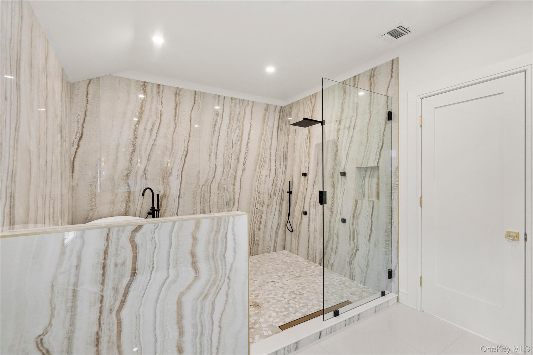 9 Wilderness Road St. James, NY 11780 - Photo 21 of 44 Spa Inspired Primary Bathroom with Floor to Ceiling Tile, Soaker Tub, Rain Head Shower, Custom Niches, Dual Vanity