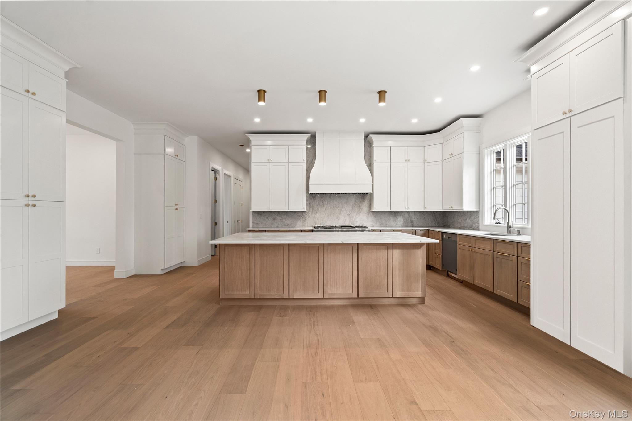 9 Wilderness Road St. James, NY 11780 - Photo 8 of 44 Chefs Kitchen with Center Island, Breakfast Area, Wide Plank White Oak Flooring, Thermador Appliances, 2 Pantries and a Butler Pantry, Over and Under Cabinet Lighting