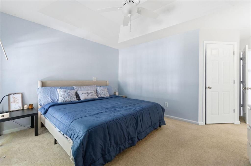 575 Reed Street Southeast Atlanta, GA 30312 - Photo 13 of 21 a bedroom with a bed and a chandelier